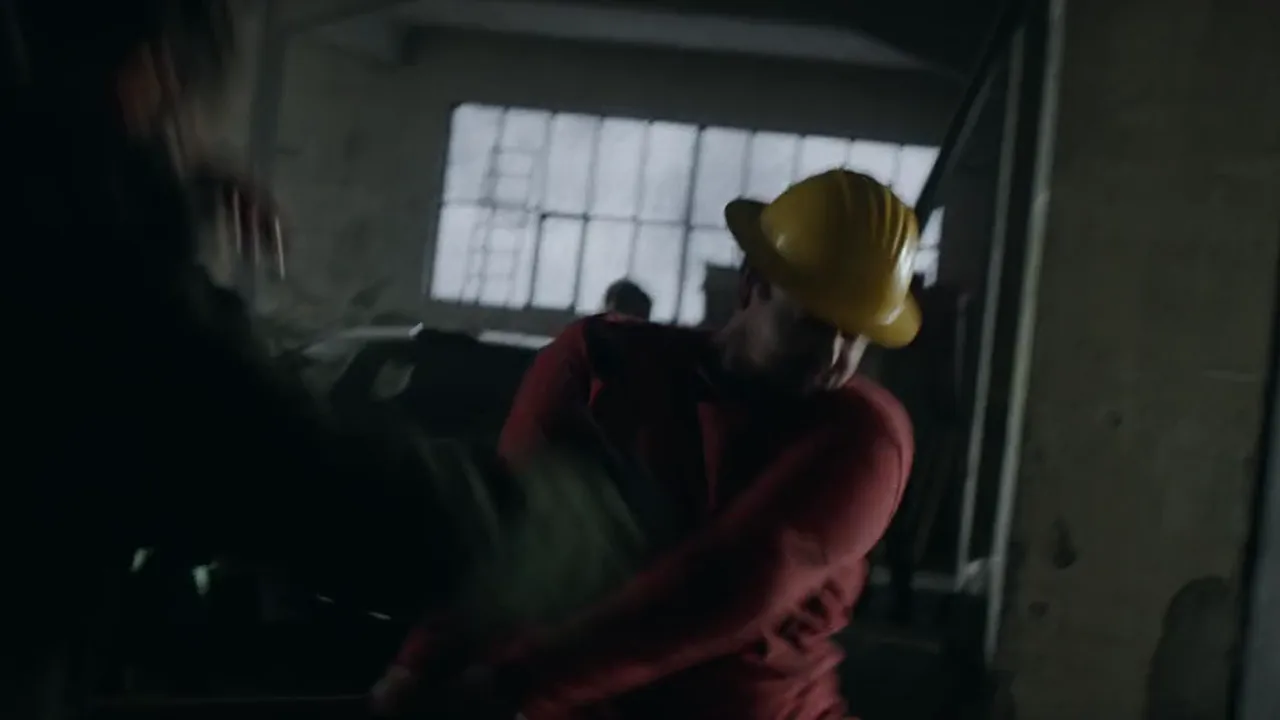 Frame from The Future Never Sleeps, a HiPhi commercial: a fight in a dark warehouse
