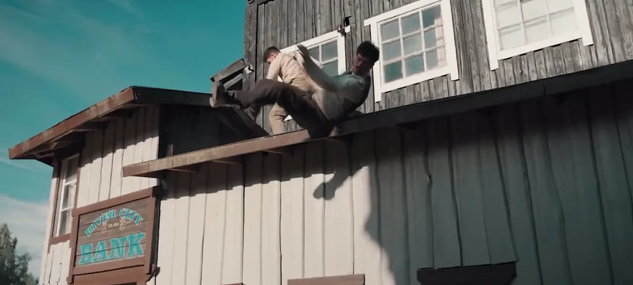A stunt performer leaps from a rooftop in a western town, from the Battleblade action design reel, the first shot of the sequence