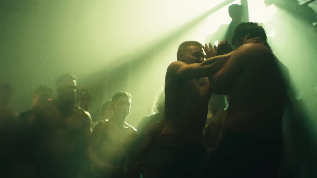 Shirtless fighters in a smoky, green-lit crowd, from the Roc Boyz music video Sett deg ned