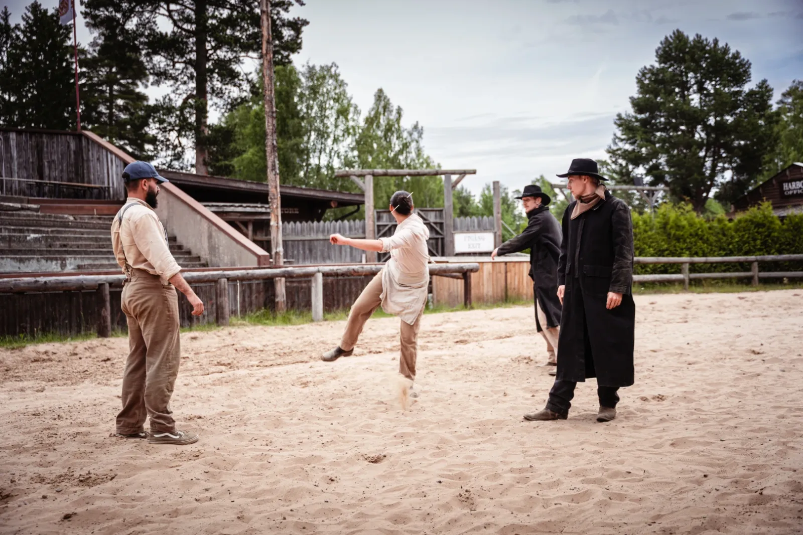 Performers rehearsing a fight on a western film set